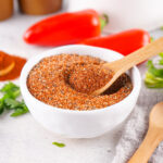 Wooden spoon in a bowl of BBQ rub.