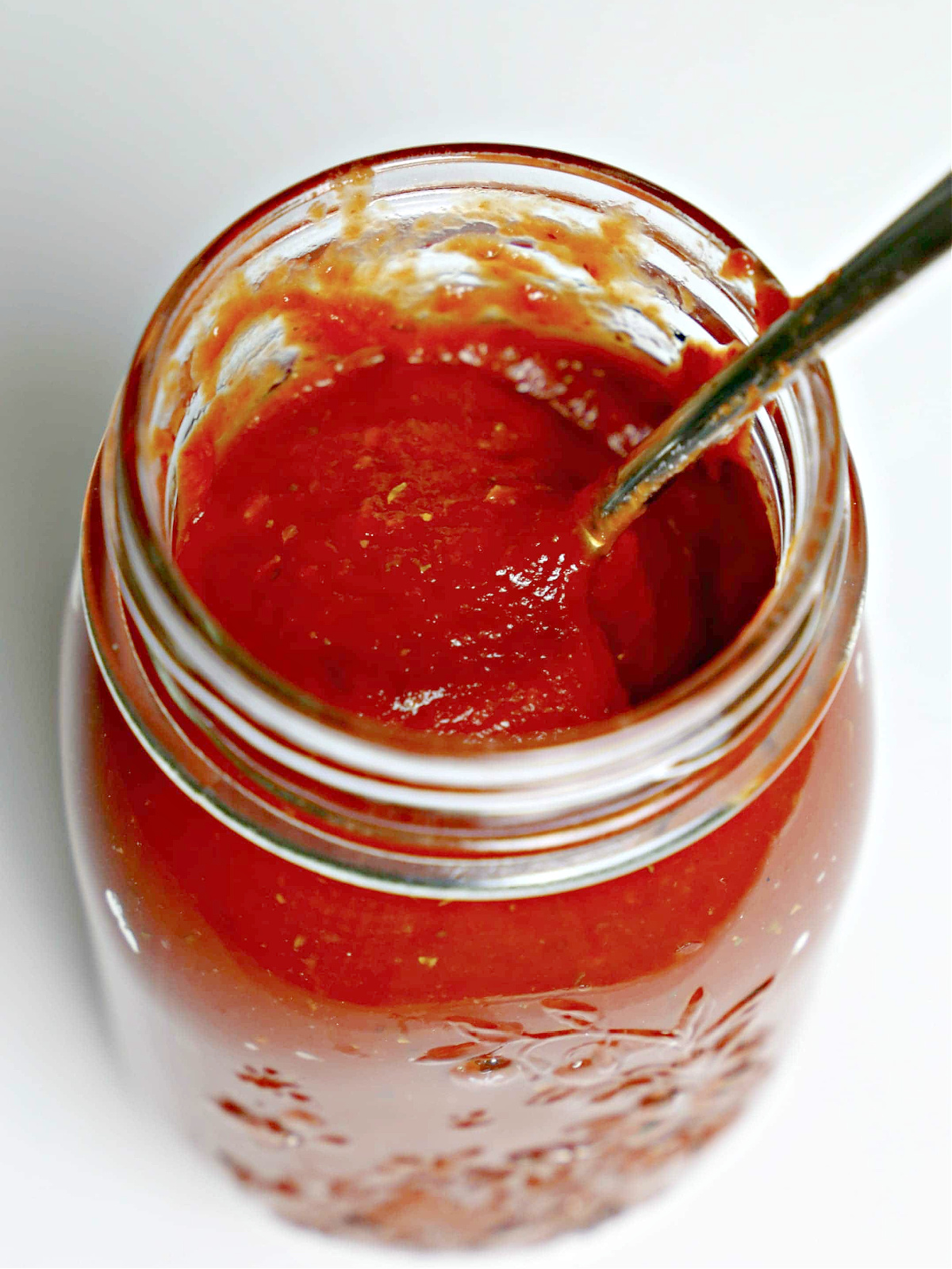 Homemade pizza sauce in a glass jar.