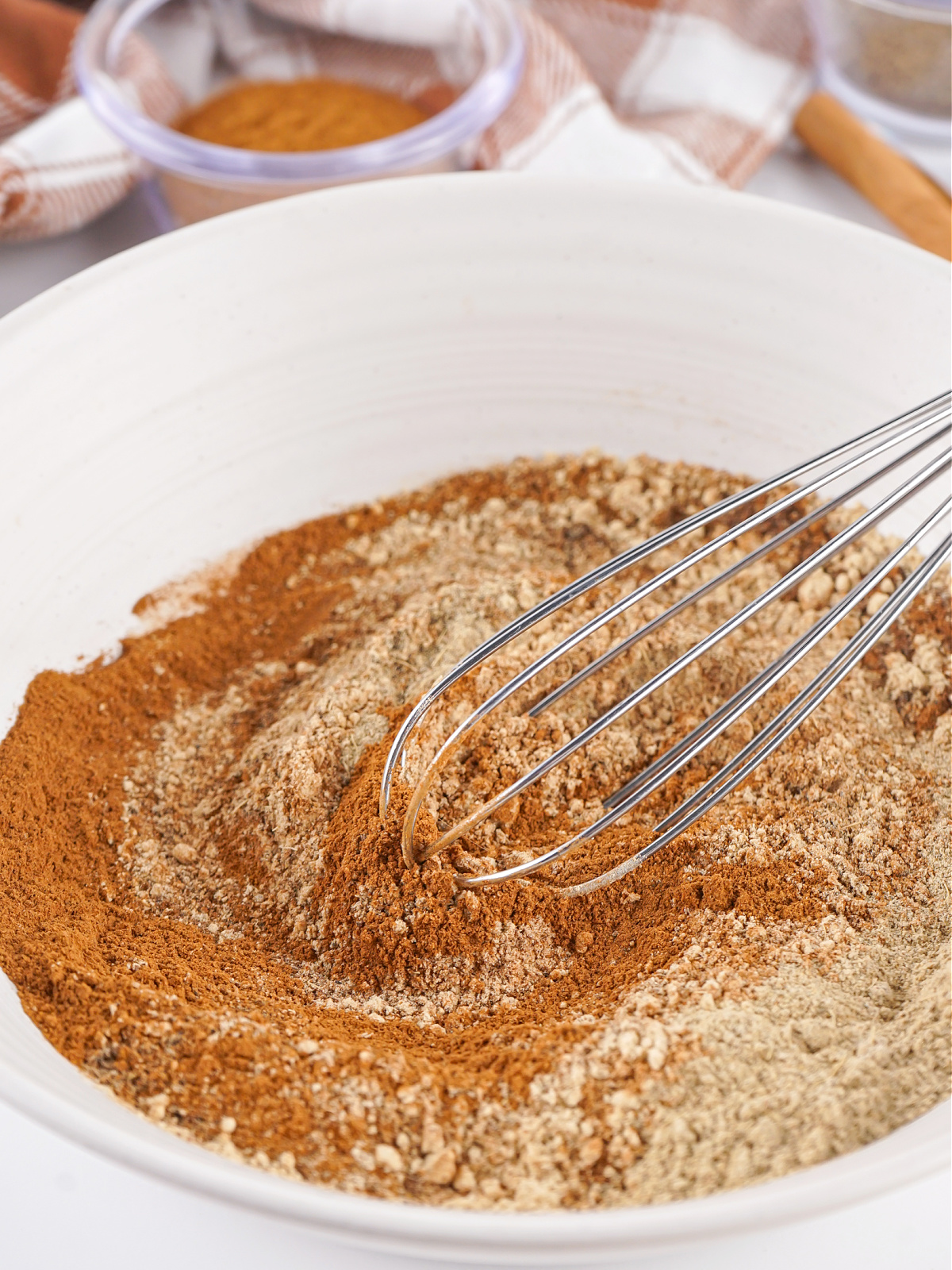 Spices being whisked together in a bowl.