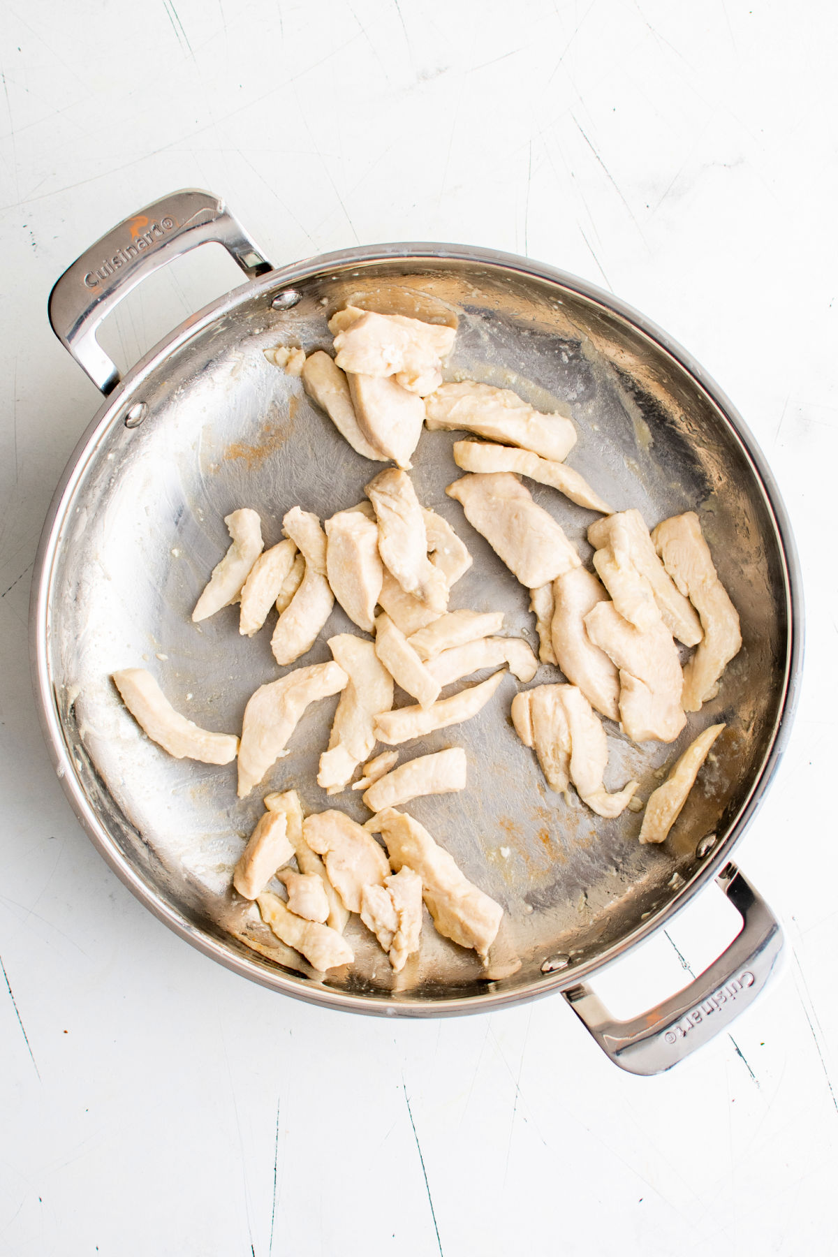 Cooked chicken in a metal skillet.