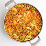 Skillet of chicken paella with chorizo.