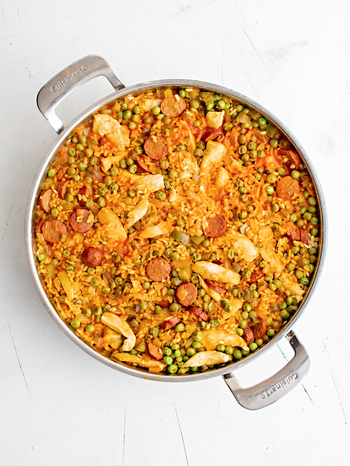 Skillet of chicken paella with chorizo.