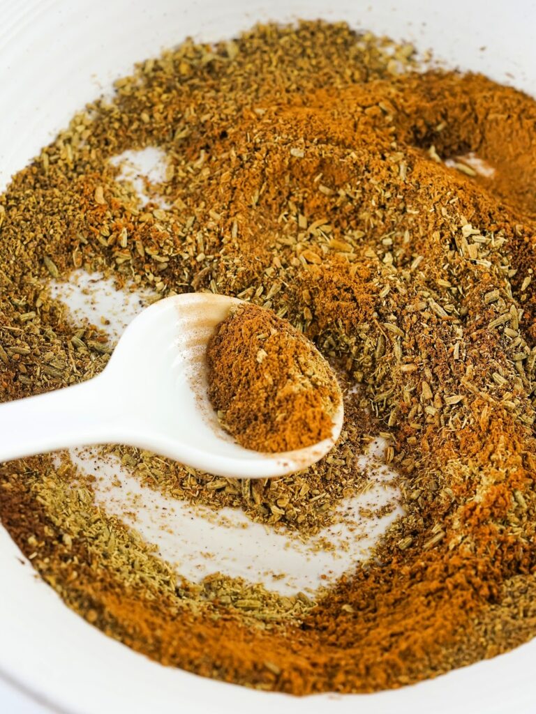 Spices being stirred together in a bowl.