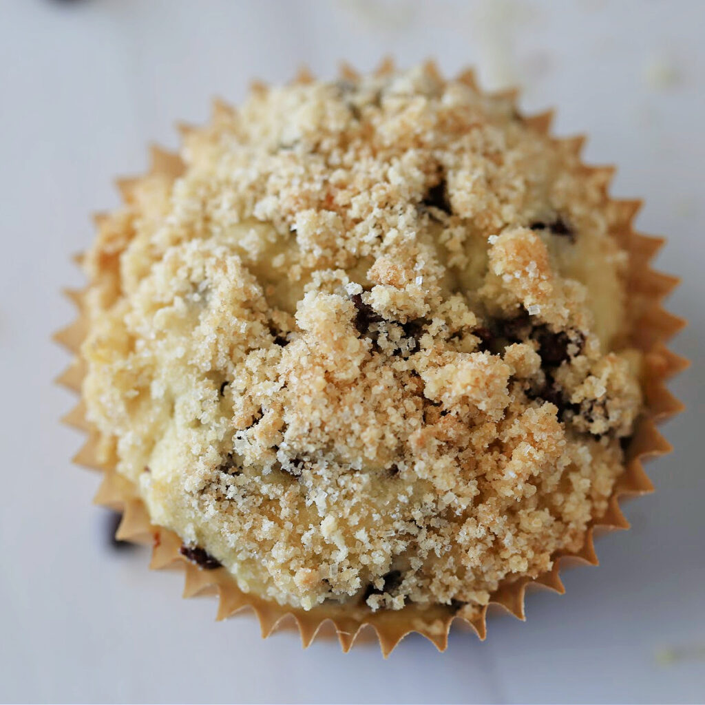 Chocolate chip muffin with a sweet, crumbly topping.