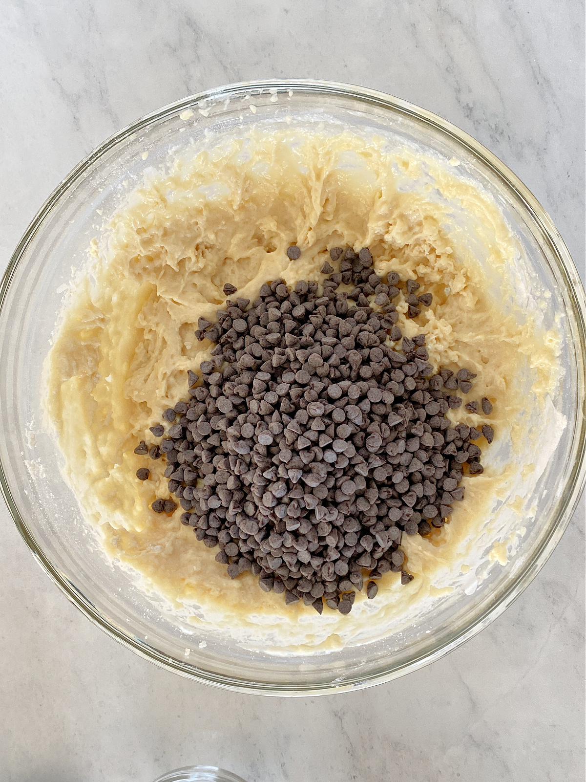 Chocolate chips being added to muffin batter.