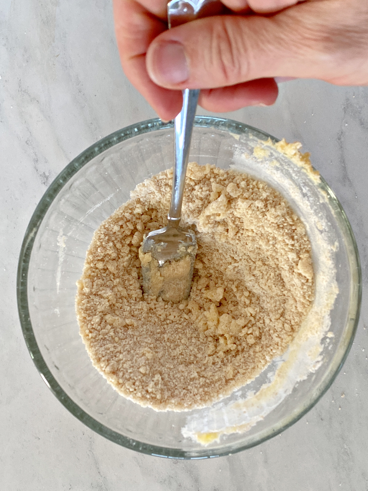 Flour, sugar, and butter being mixed together.