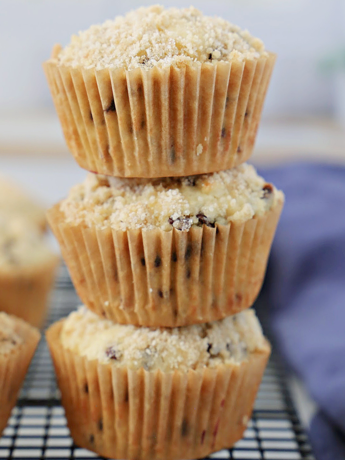 Stack of three chocolate chip muffins.