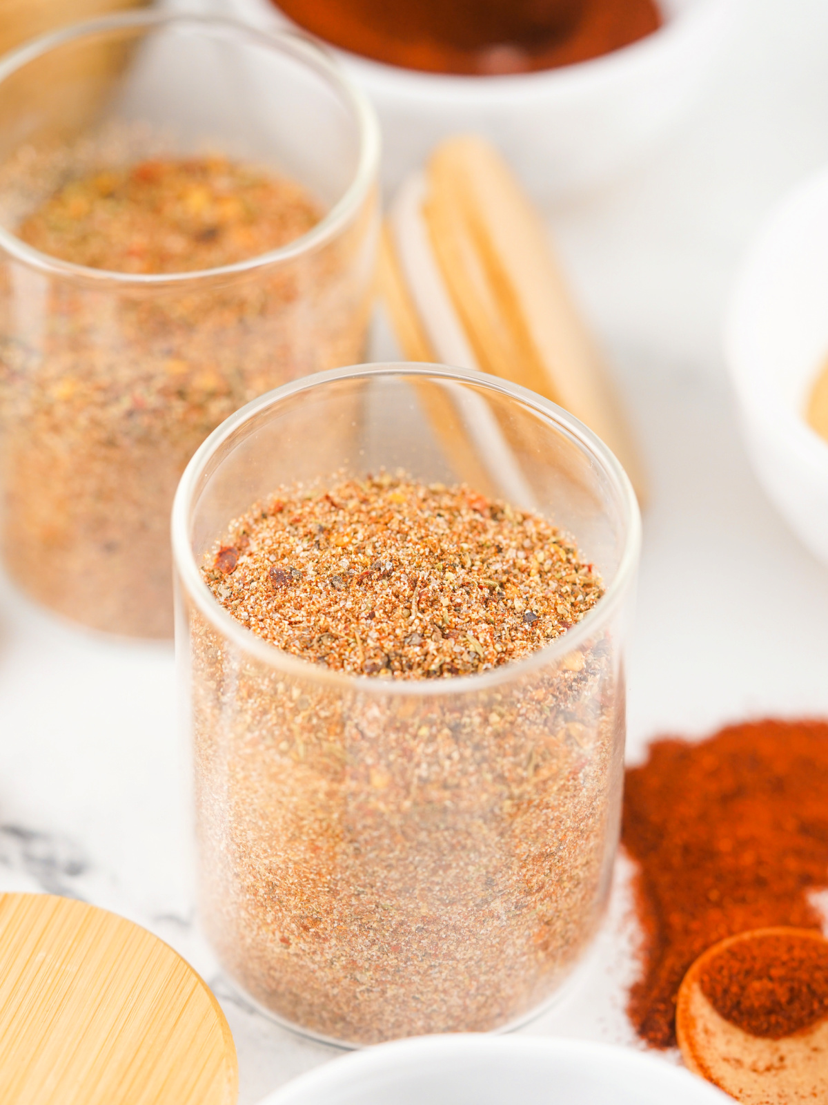 Small glass jar filled with Jamaican Jerk Seasoning.