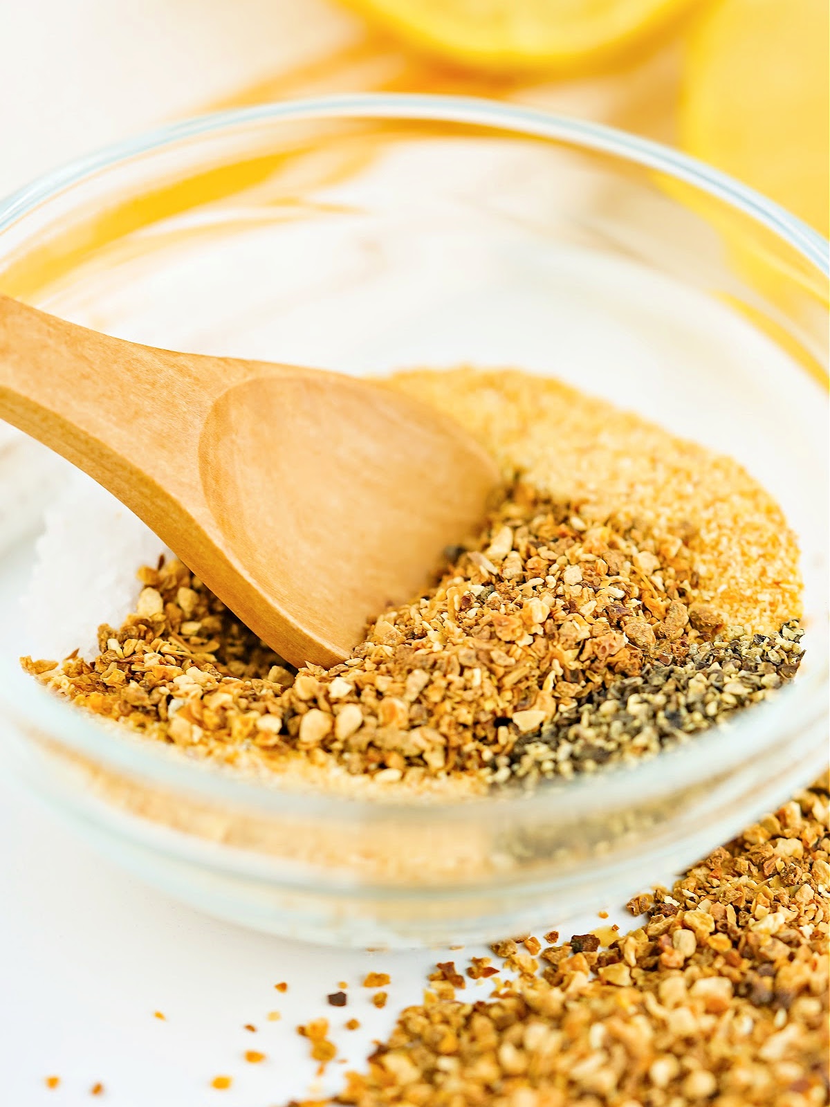 Wooden spoon in a mixing bowl of seasoning.