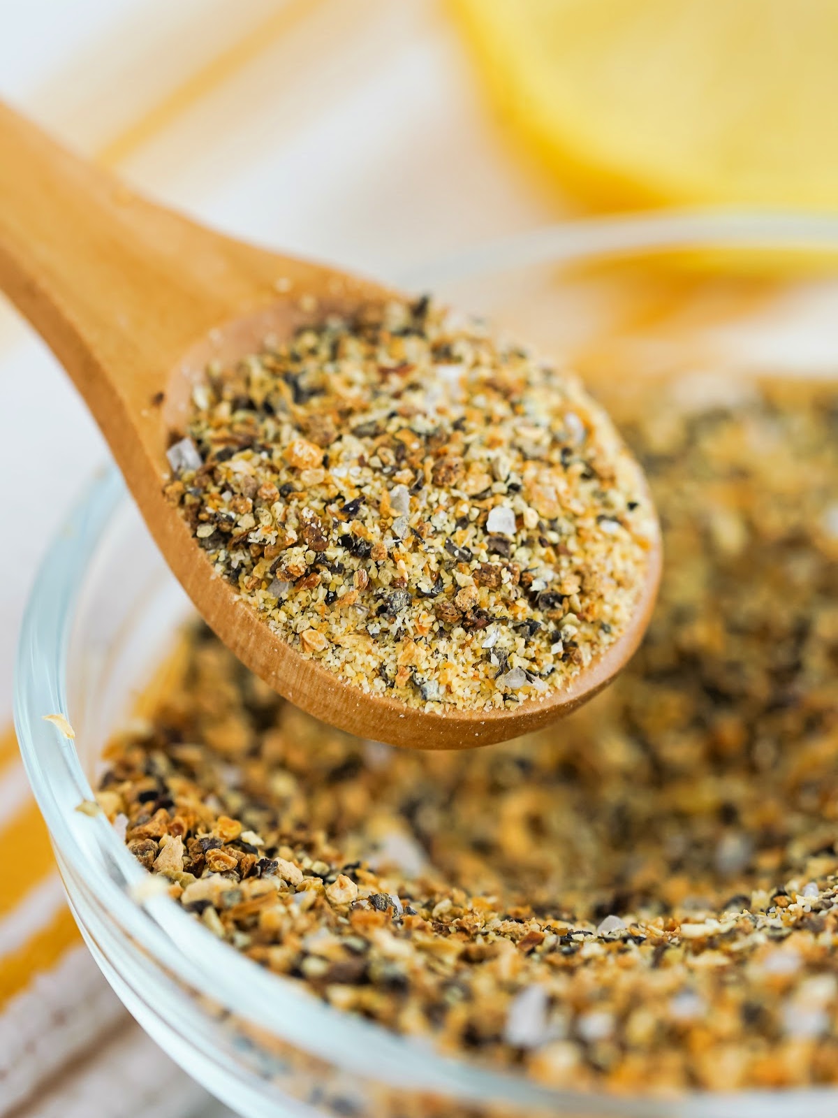 Wooden spoon with lemon pepper seasoning.