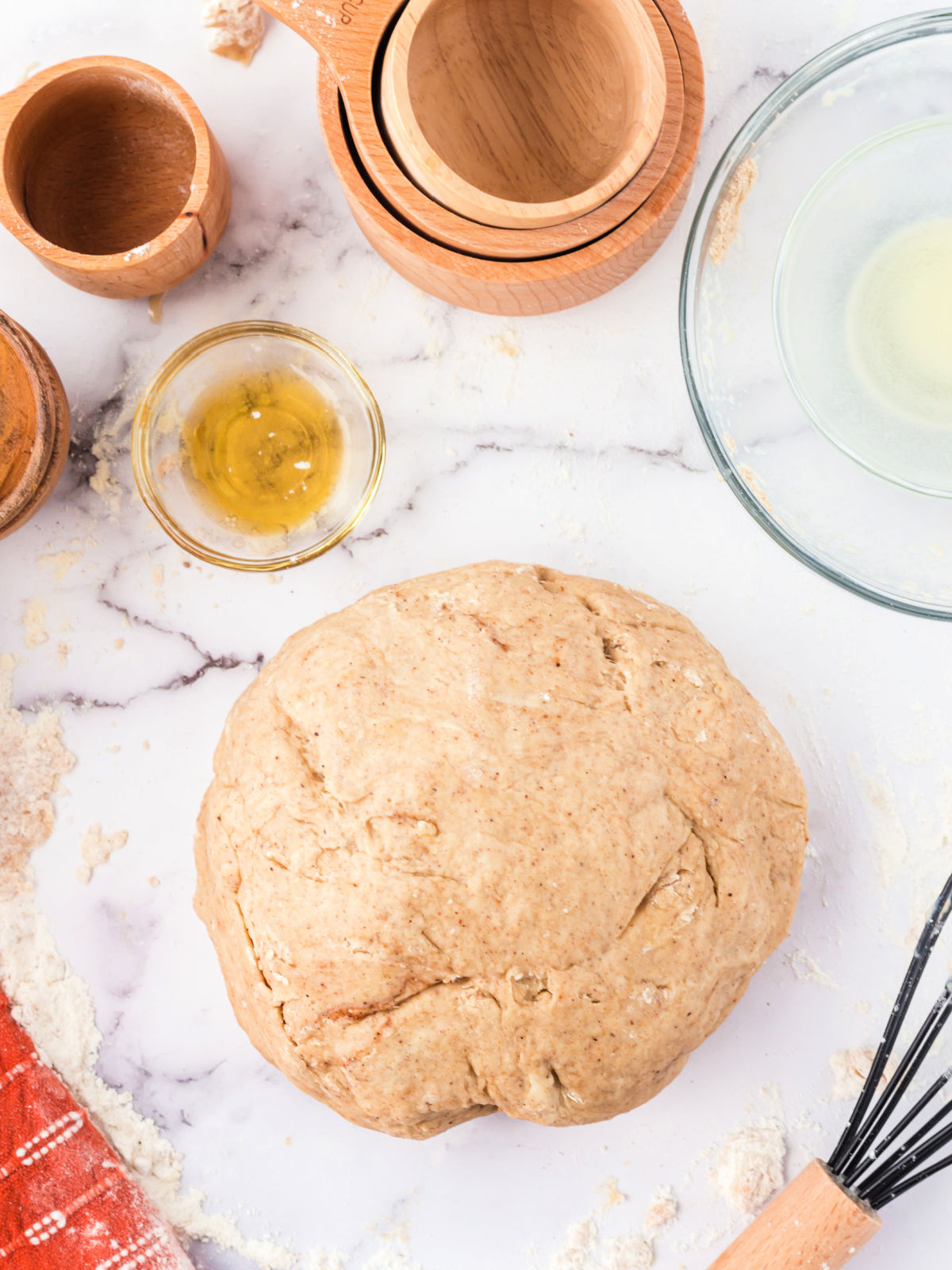 Ball of doughnut dough on a countertop.