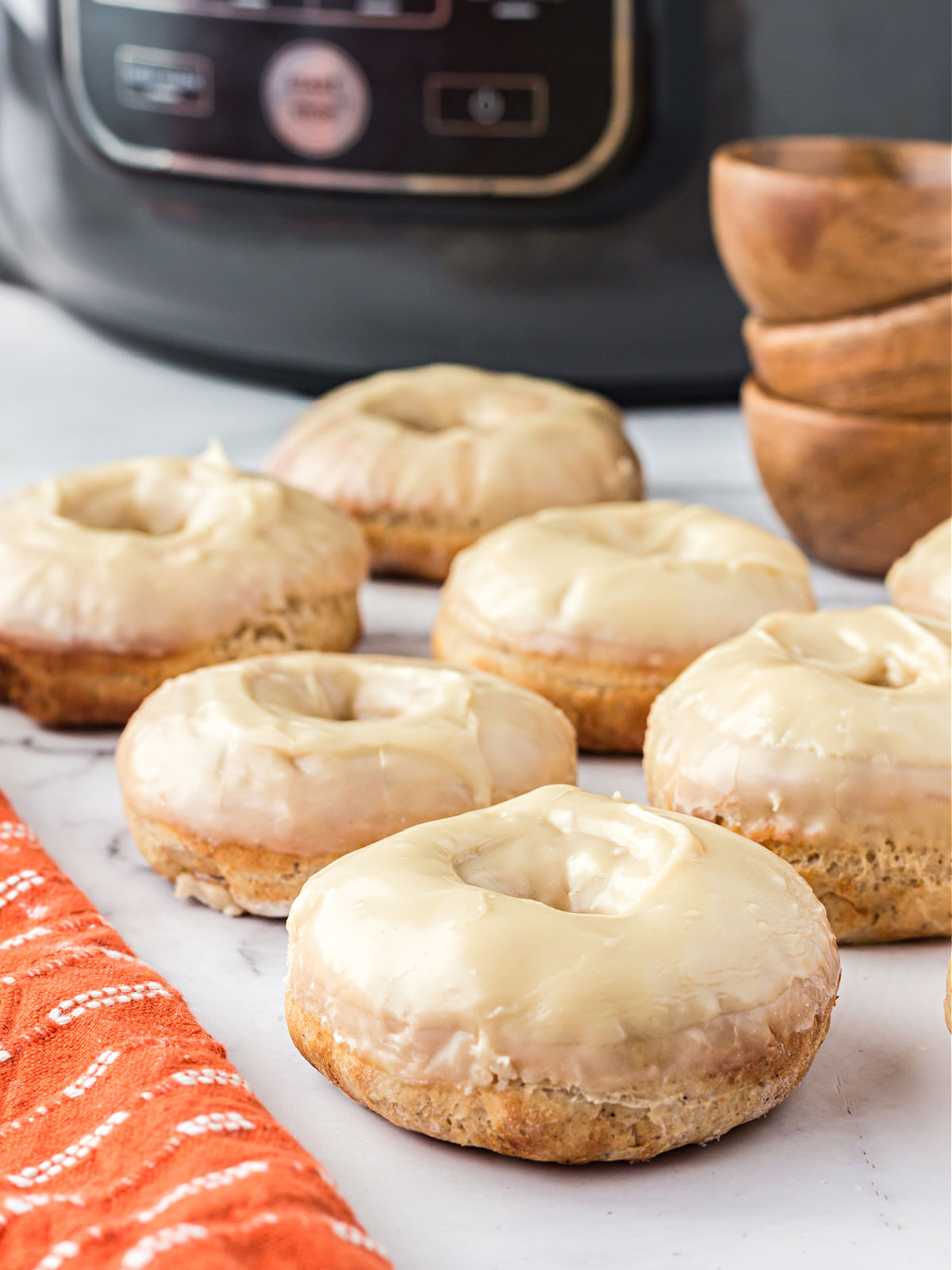 Iced doughnuts on a countertop.