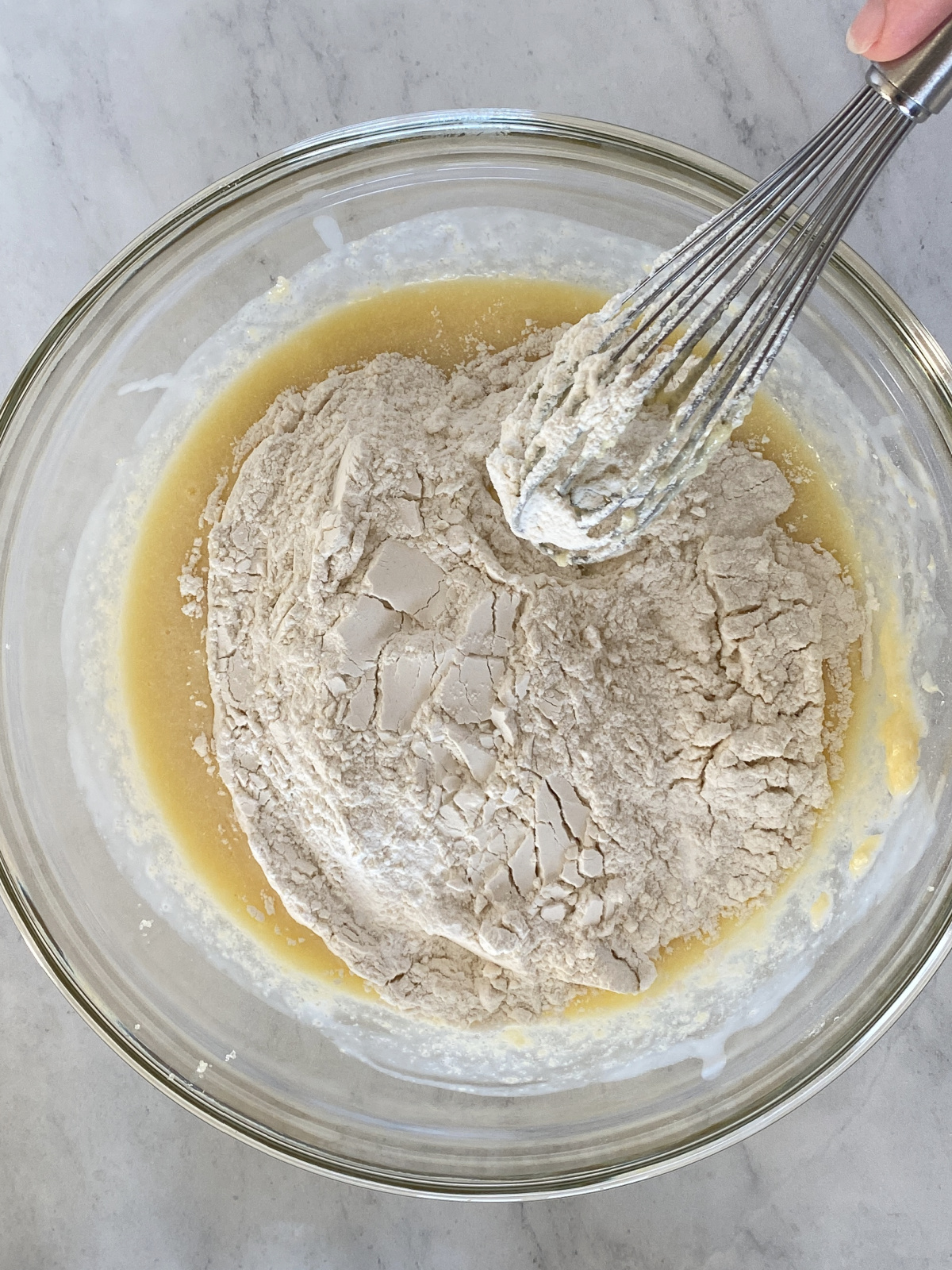 Flour mixture and wet mixture being whisked together.