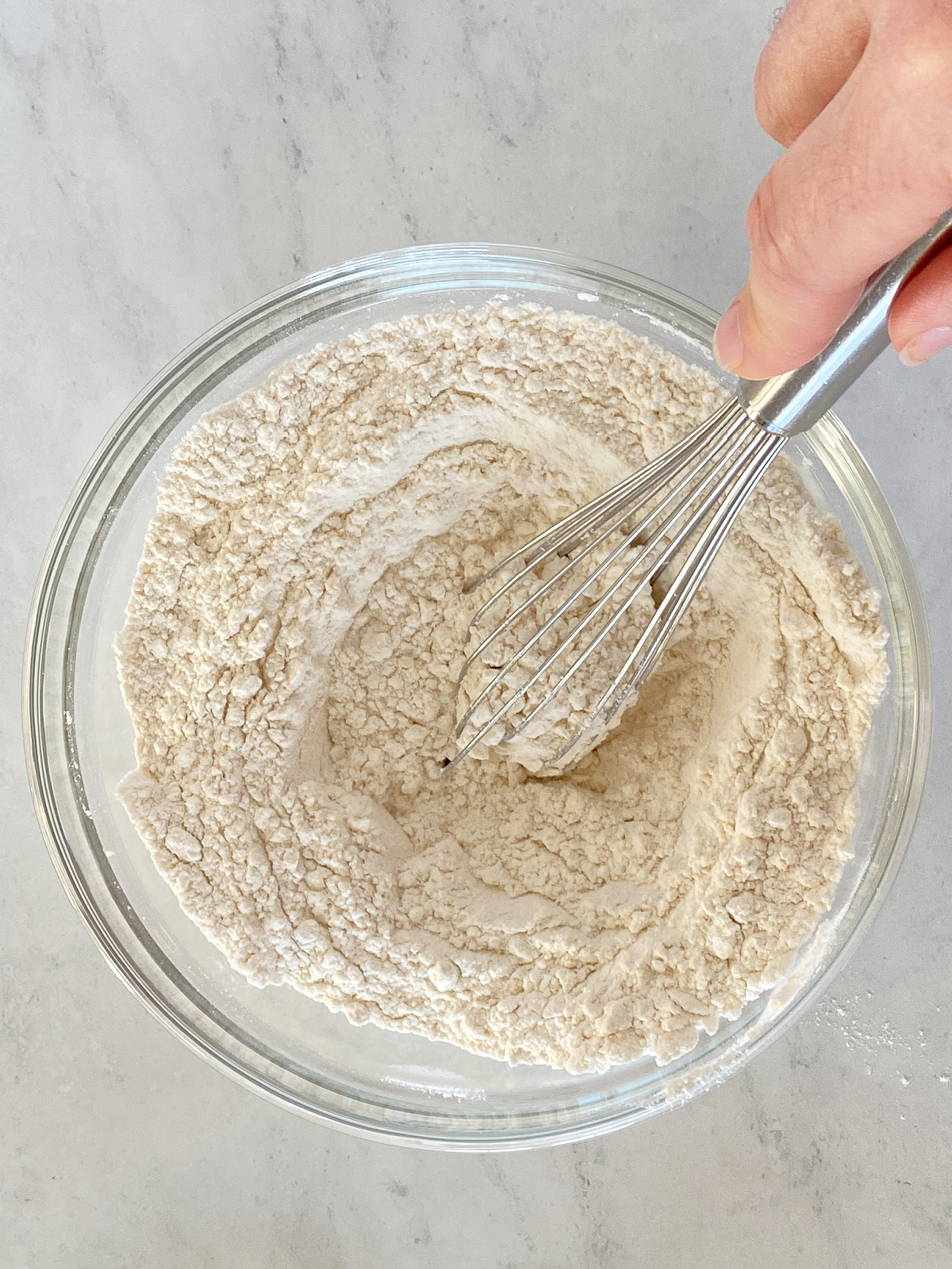 Flour mixture being whisked in a bowl.