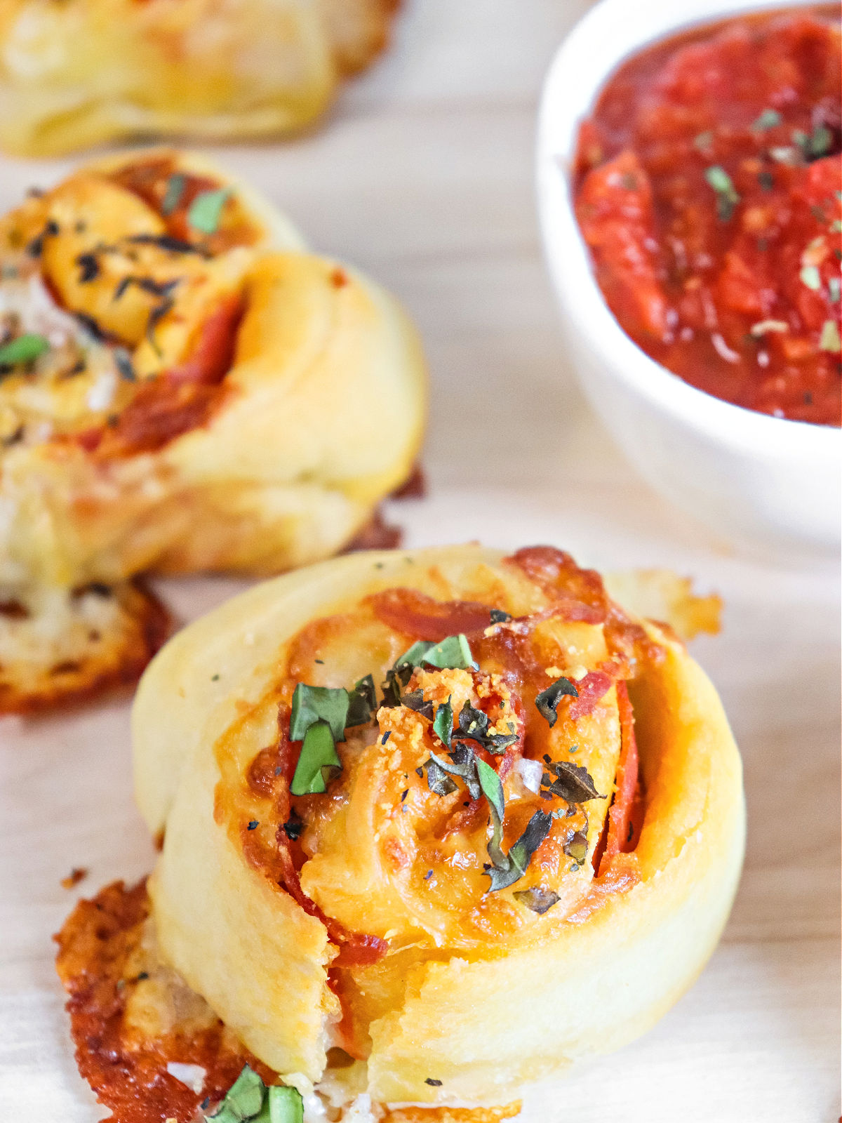 Baked pepperoni pizza bites with pizza dipping sauce.