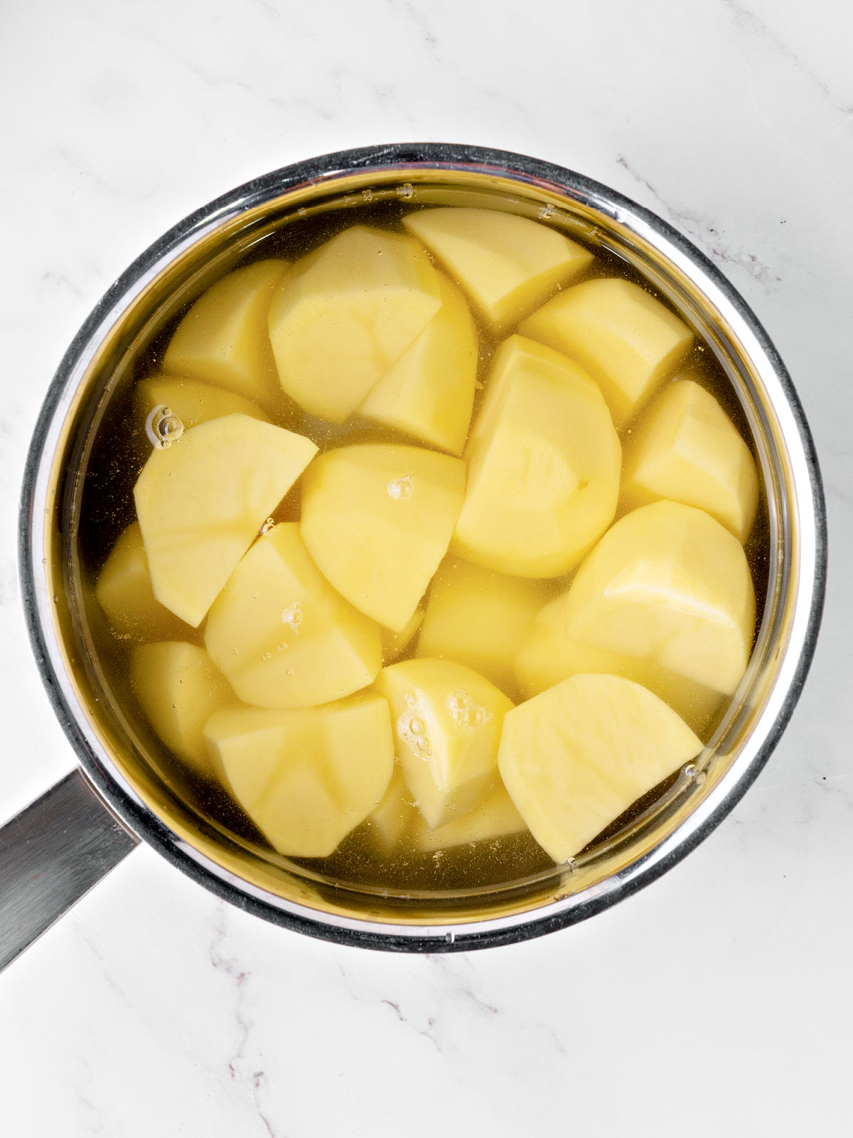 Potatoes cooking in a pot.