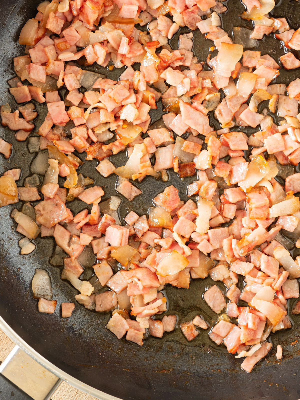 Bacon cooking in a skillet.