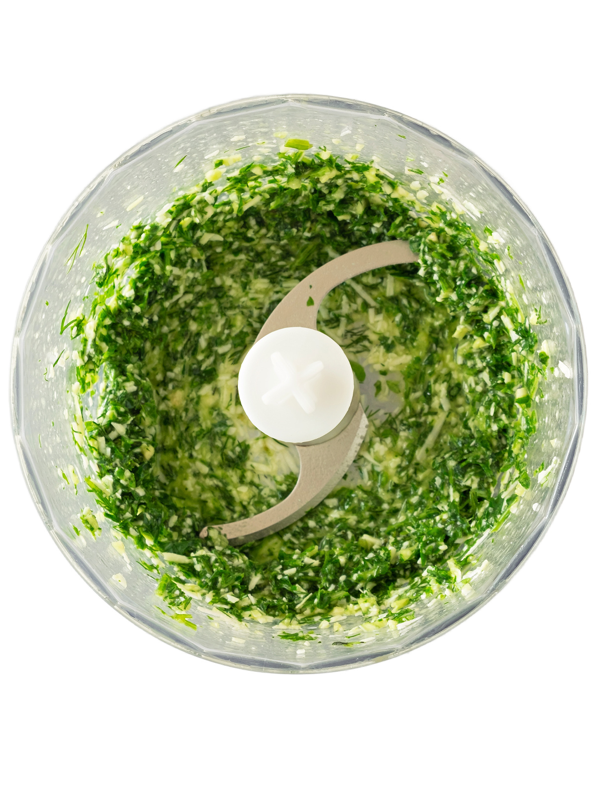 Herbs pureed in a food processor.