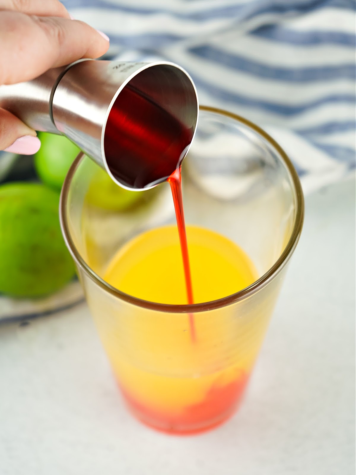 Grenadine being poured into a glass.