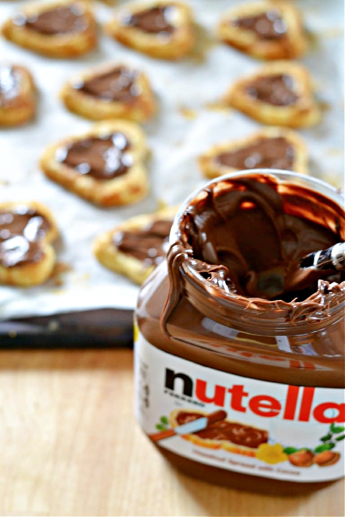 Jar of Nutella in front of a try of Nutella s'more cookies.