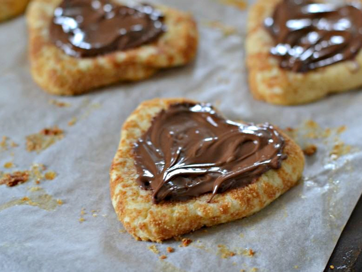 Heart-shaped thumbprint cookies filled with Nutella.