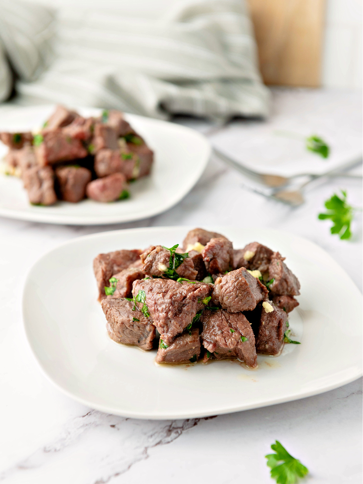 Plates of seasoned steak bites.