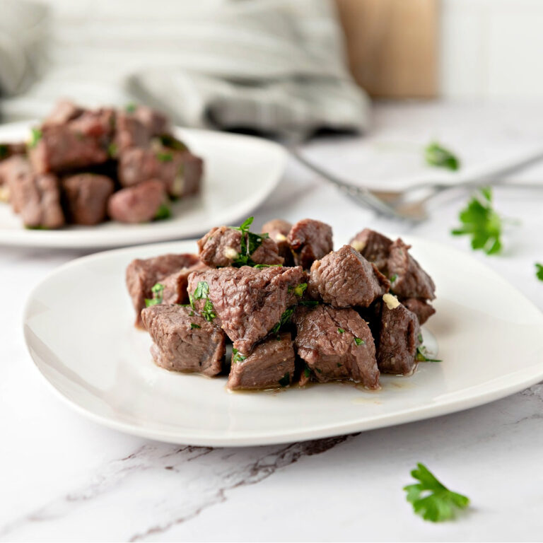 Two plates of steak bites.