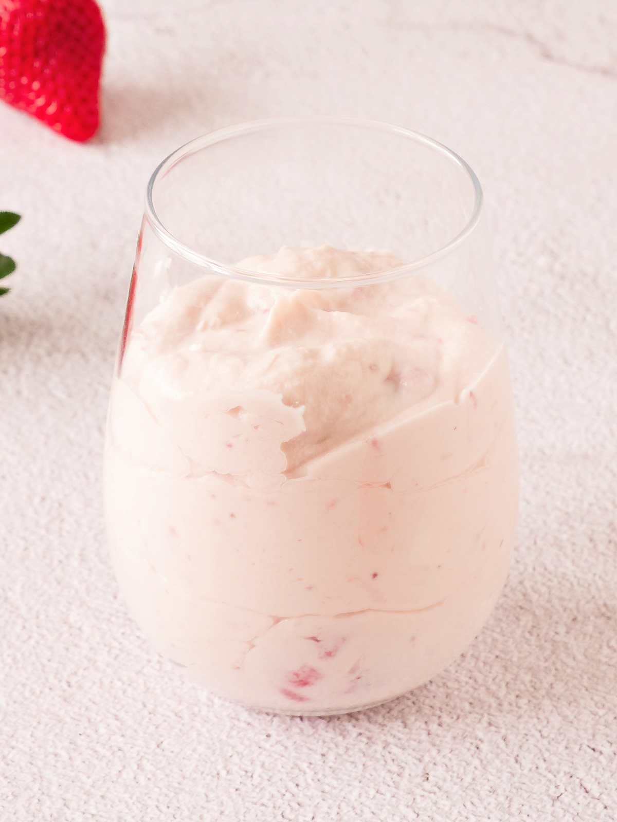 Strawberry mousse in the bottom of a glass.