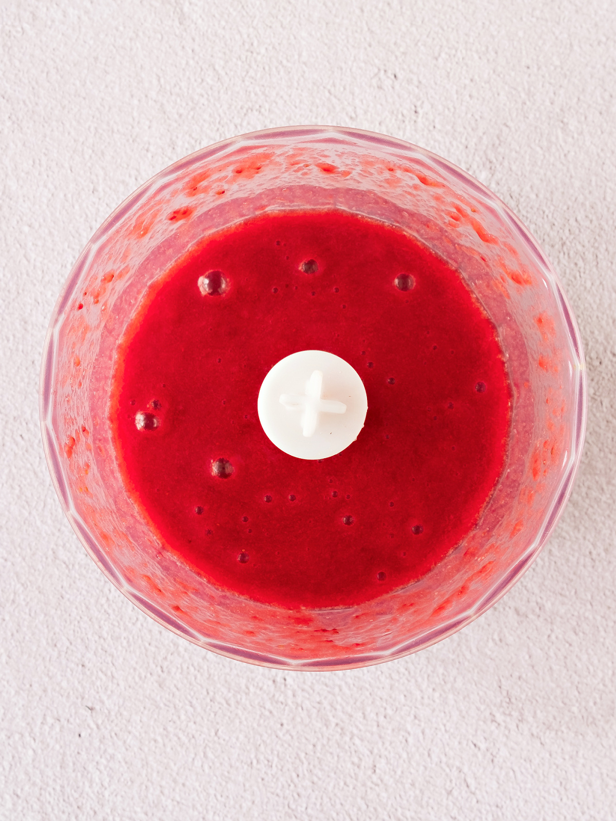 Pureed strawberries in a food processor.