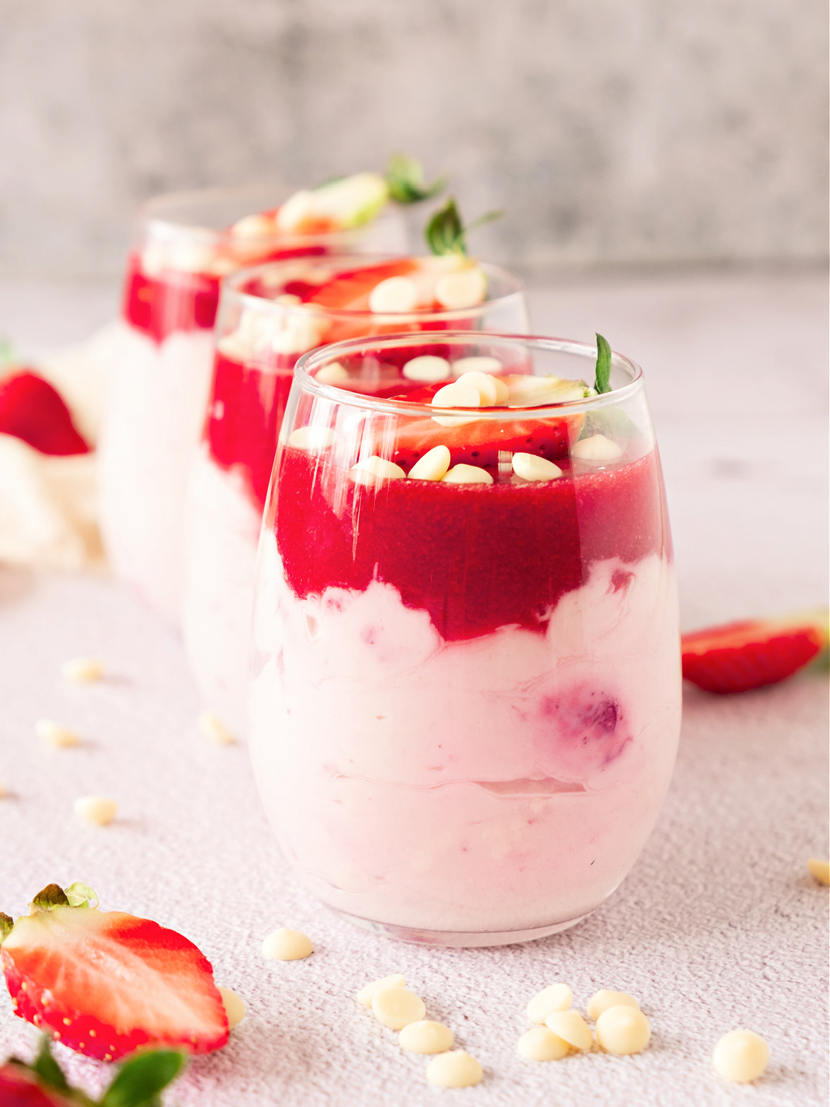 Three glasses filled with strawberry mousse.