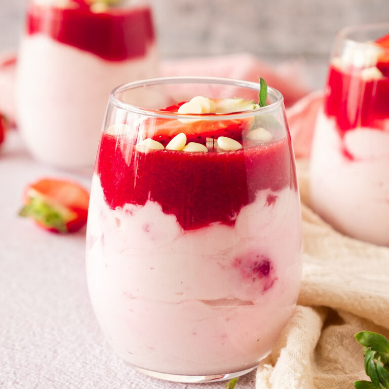 Strawberry mousse topped with a fresh strawberry and white chocolate chips.