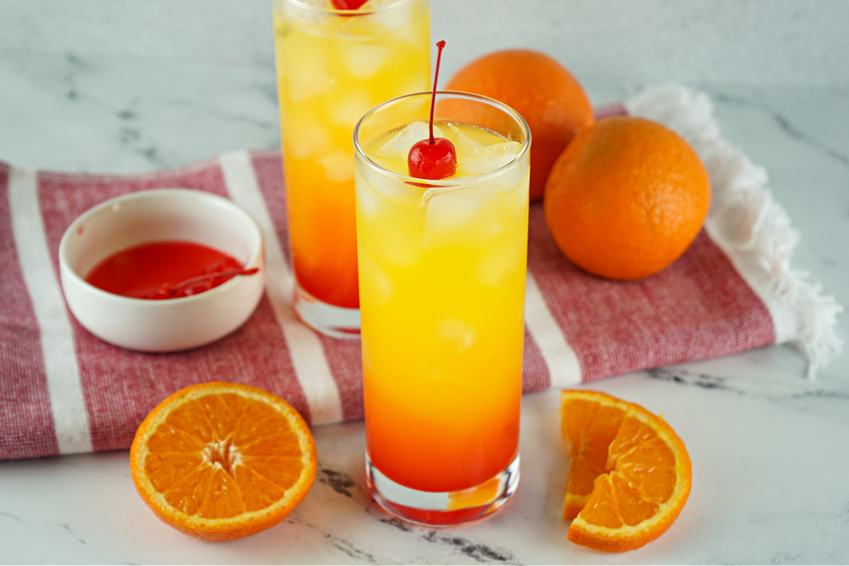 Two glasses of Tequila Sunrise and a couple of oranges.