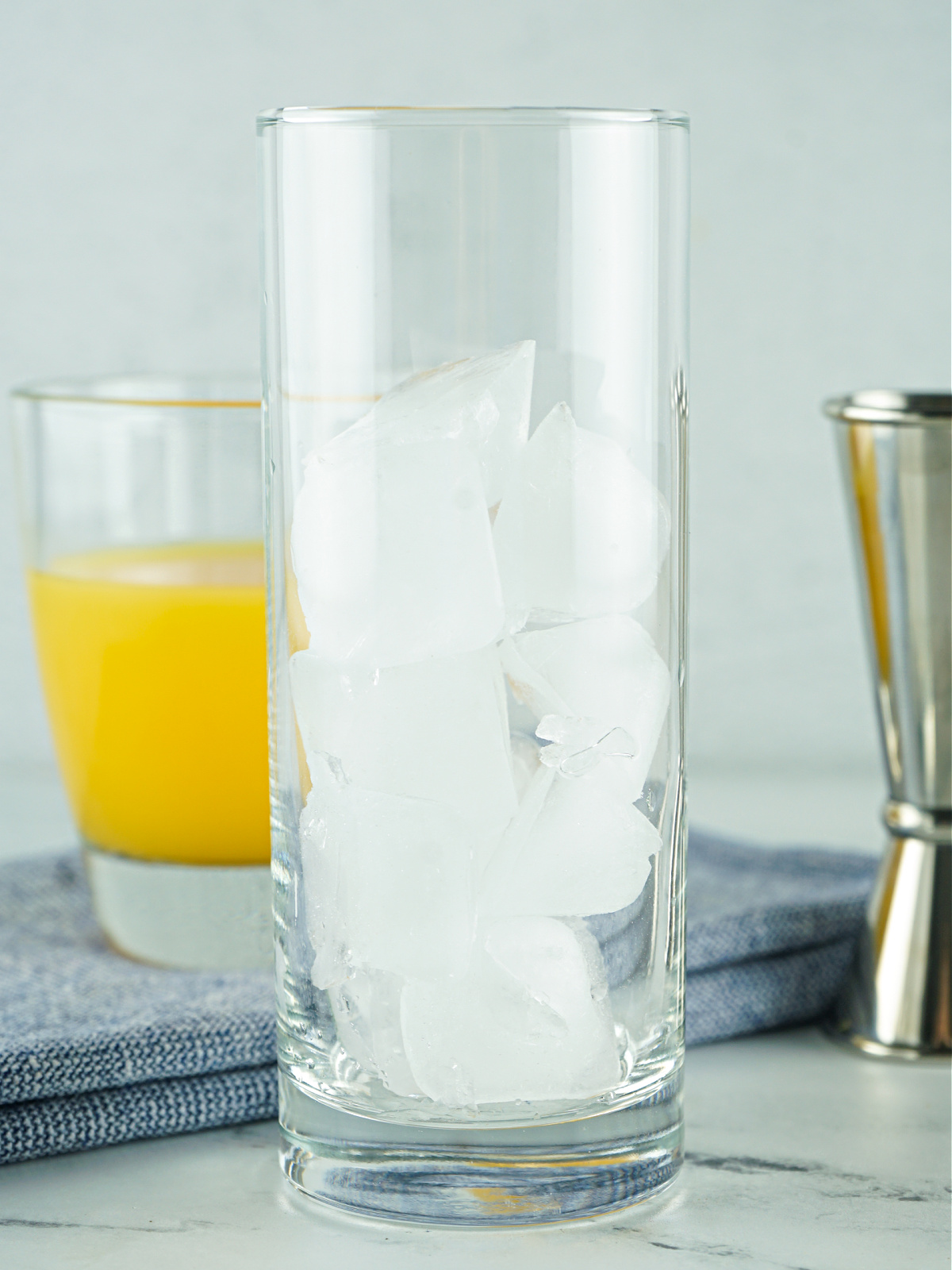 A tall glass filled with ice.