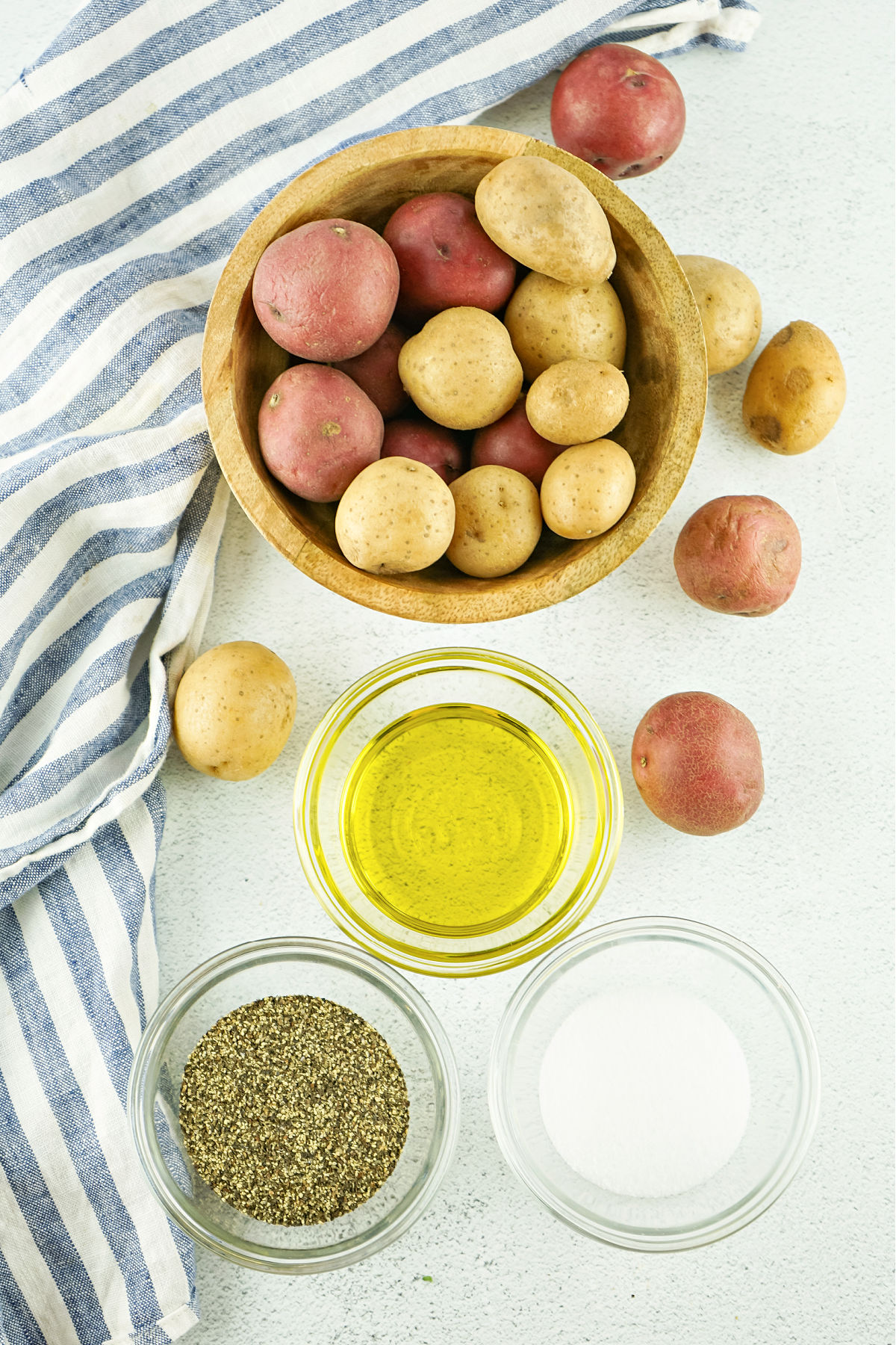 Red and yellow potatoes, oil, salt, and pepper.