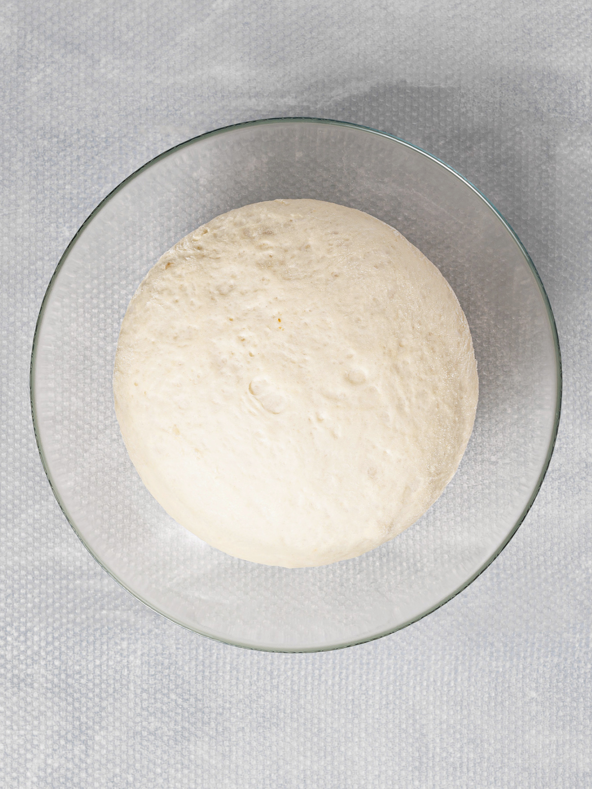 Proofed dough in a bowl.