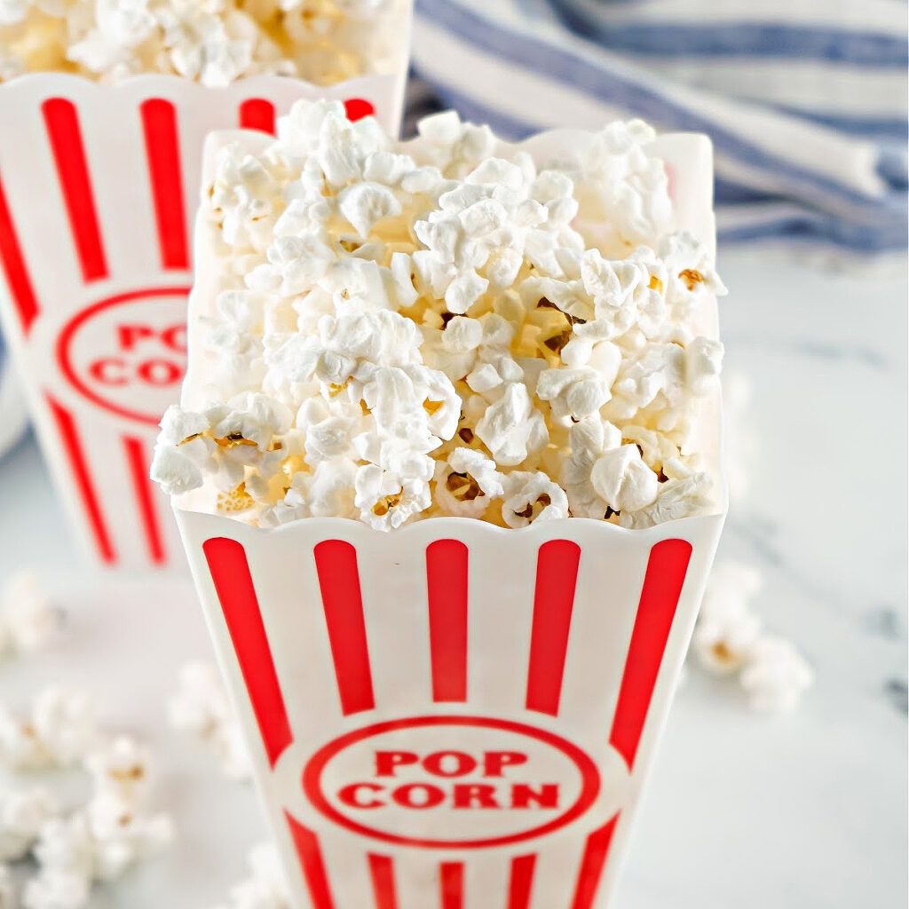 Popcorn in a red and white container.