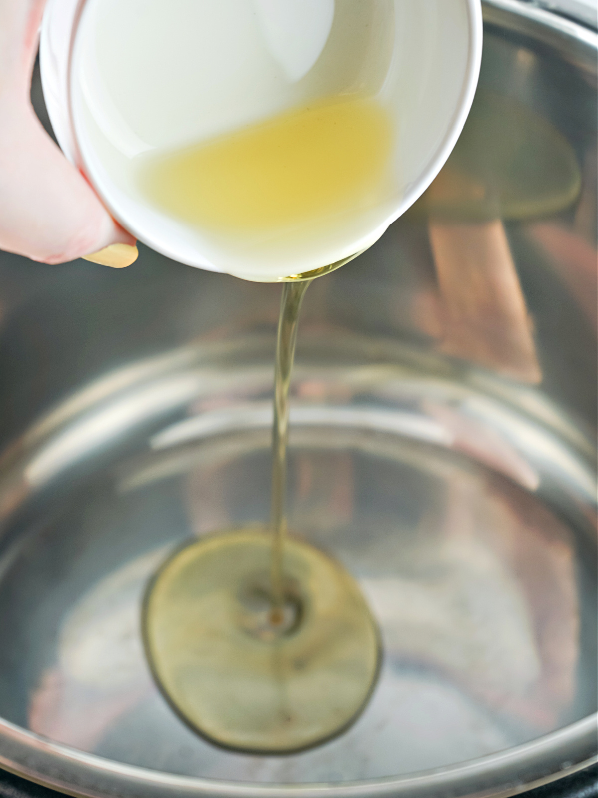 Pouring oil into a pot.