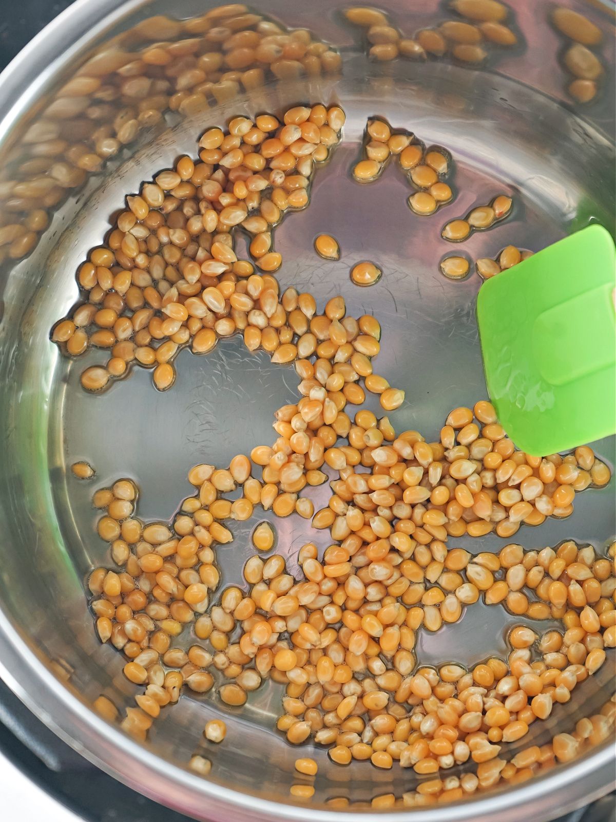 Stirring popcorn kernels in an Instant Pot.