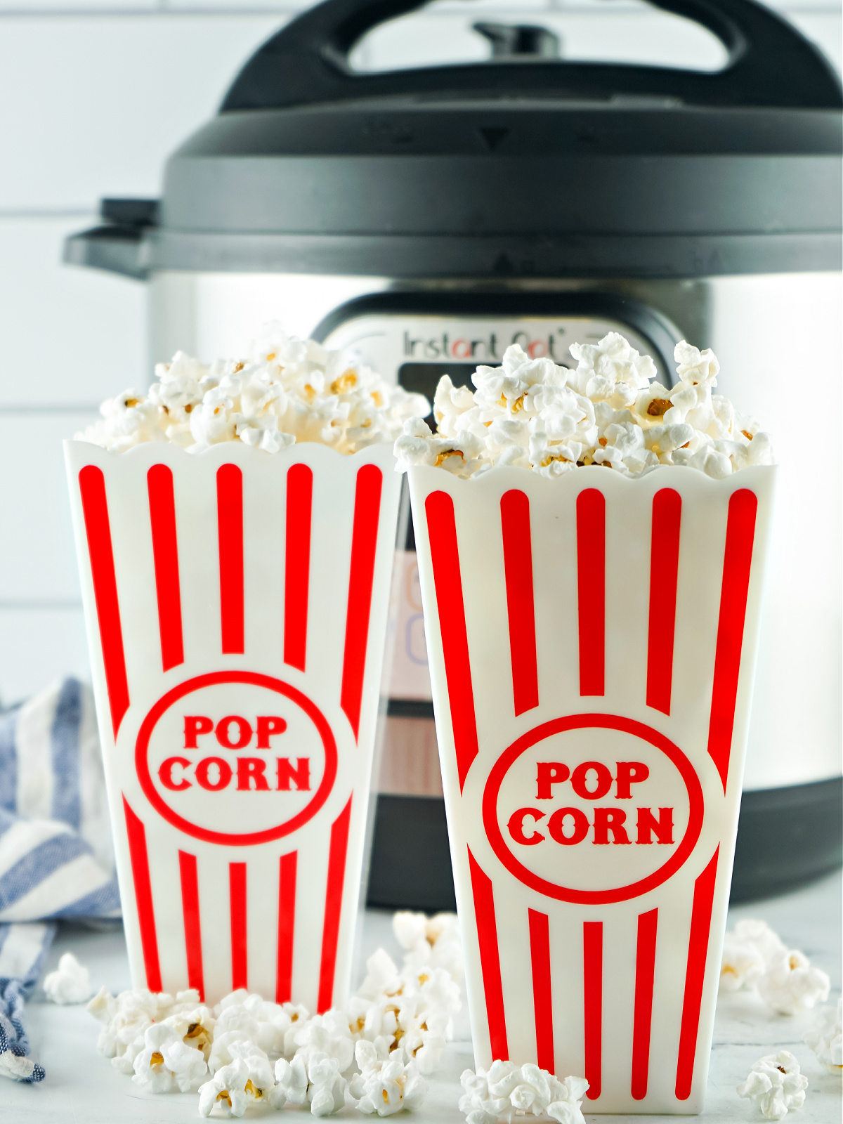 Two containers filled with popcorn in front of an Instant Pot.